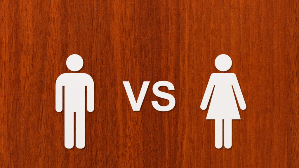 Man symbol versus  woman symbol on a wooden background